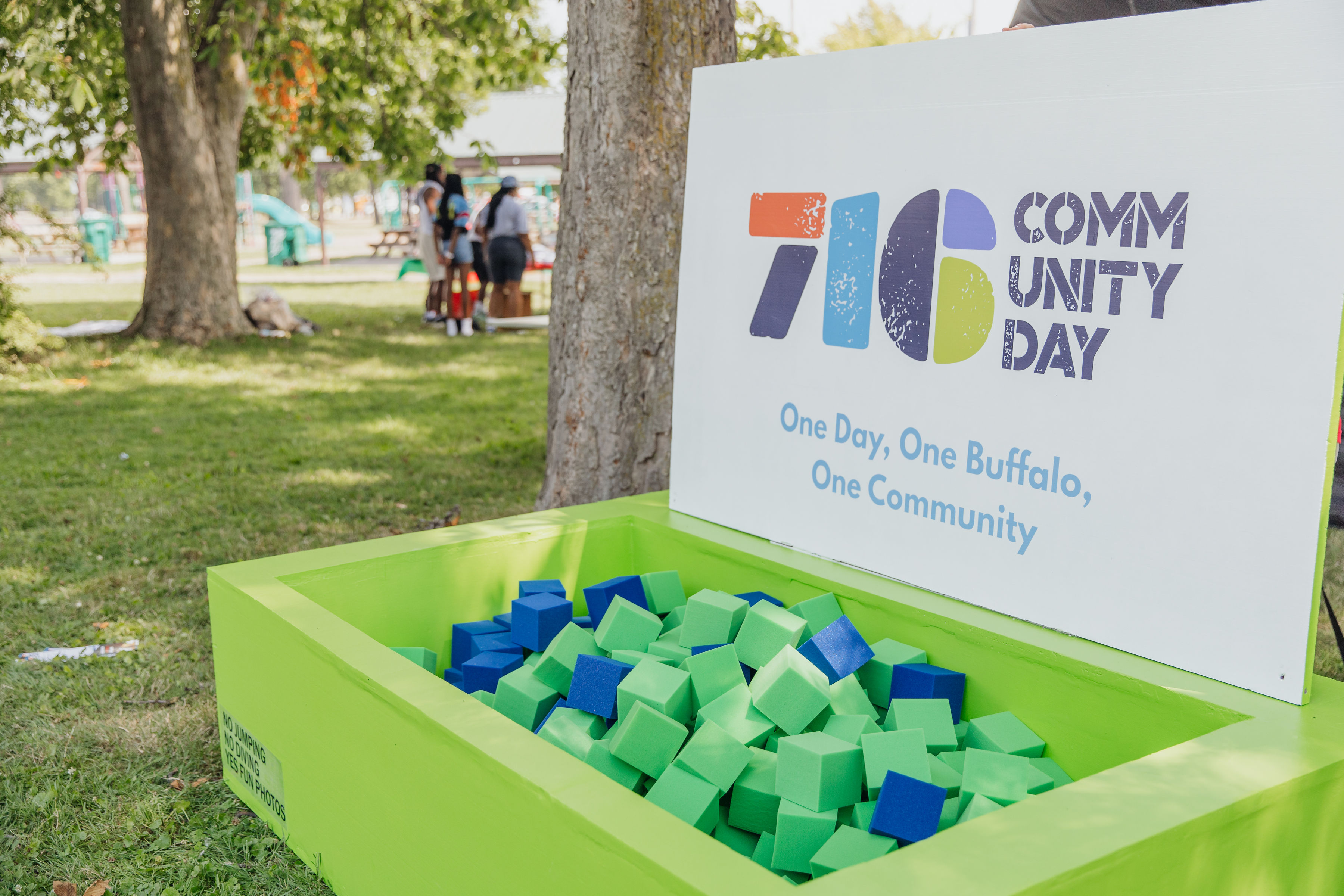 A crowd of volunteers and families gathered at a Trusted Gives community event