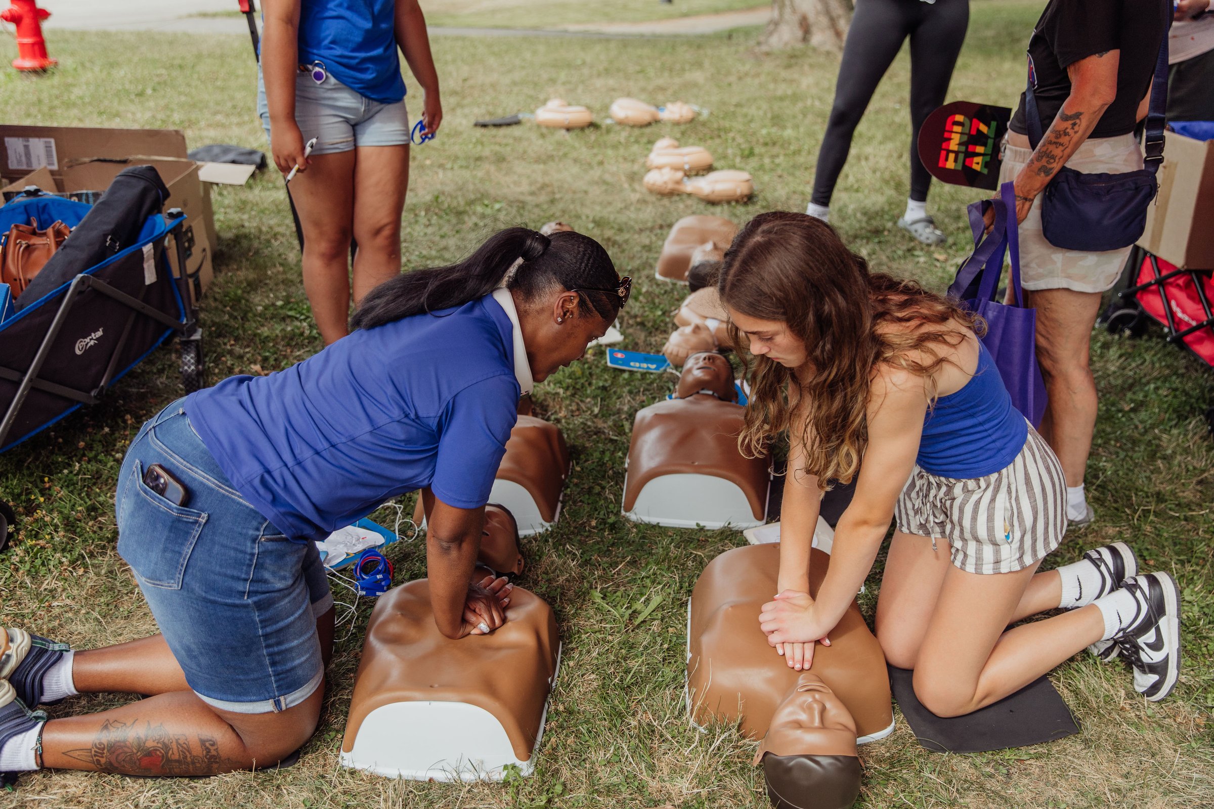 Volunteers learning CPR and emergency response at a Trusted Gives community event